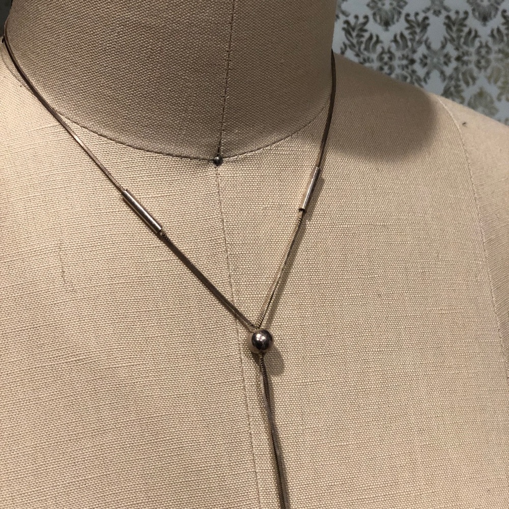 Silver necklace, best for plunging necklines.